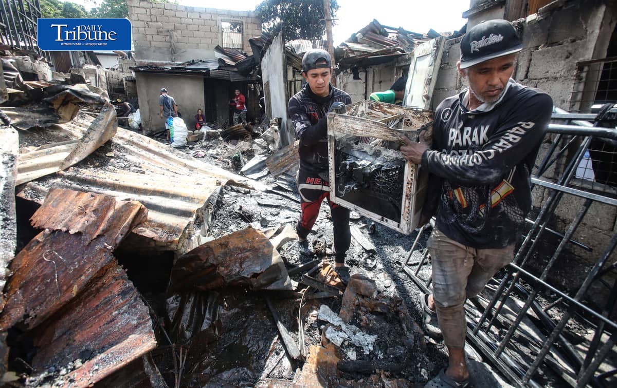 (October 07 2026) Fire victims at Waling Waling, in Brgy. Central, Quezon City on Wednesday October 7 2026, savage reusable materials lifted from the fifth alarm fire that hit in the area on Tuesday. Photo/Analy Labor