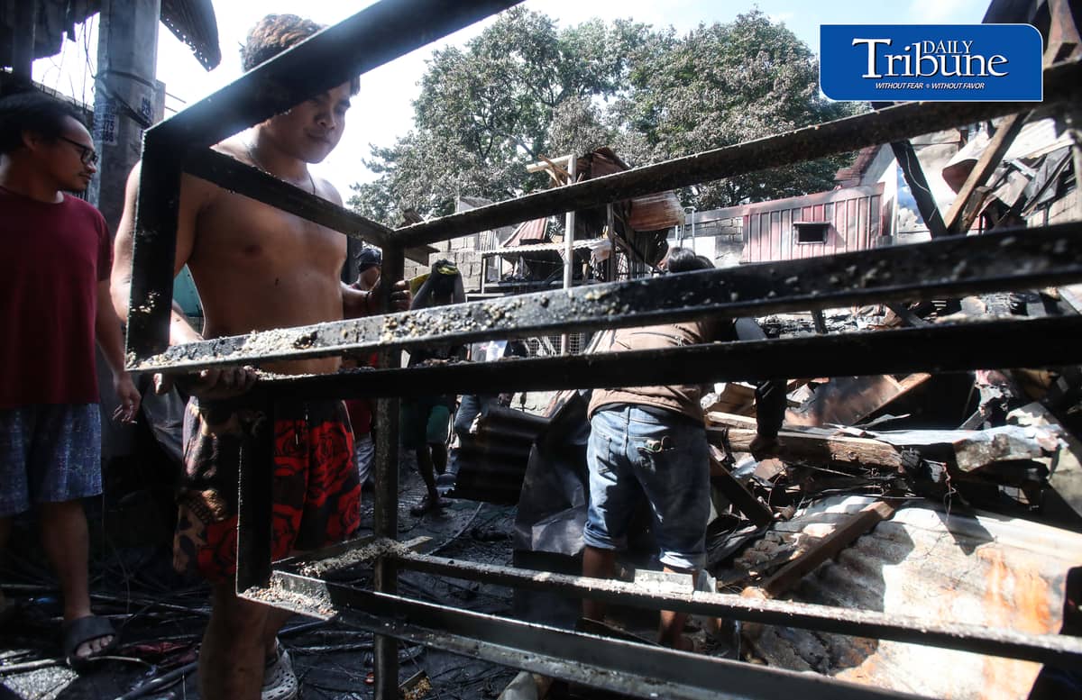(October 07 2026) Fire victims at Waling Waling, in Brgy. Central, Quezon City on Wednesday October 7 2026, savage reusable materials lifted from the fifth alarm fire that hit in the area on Tuesday. Photo/Analy Labor