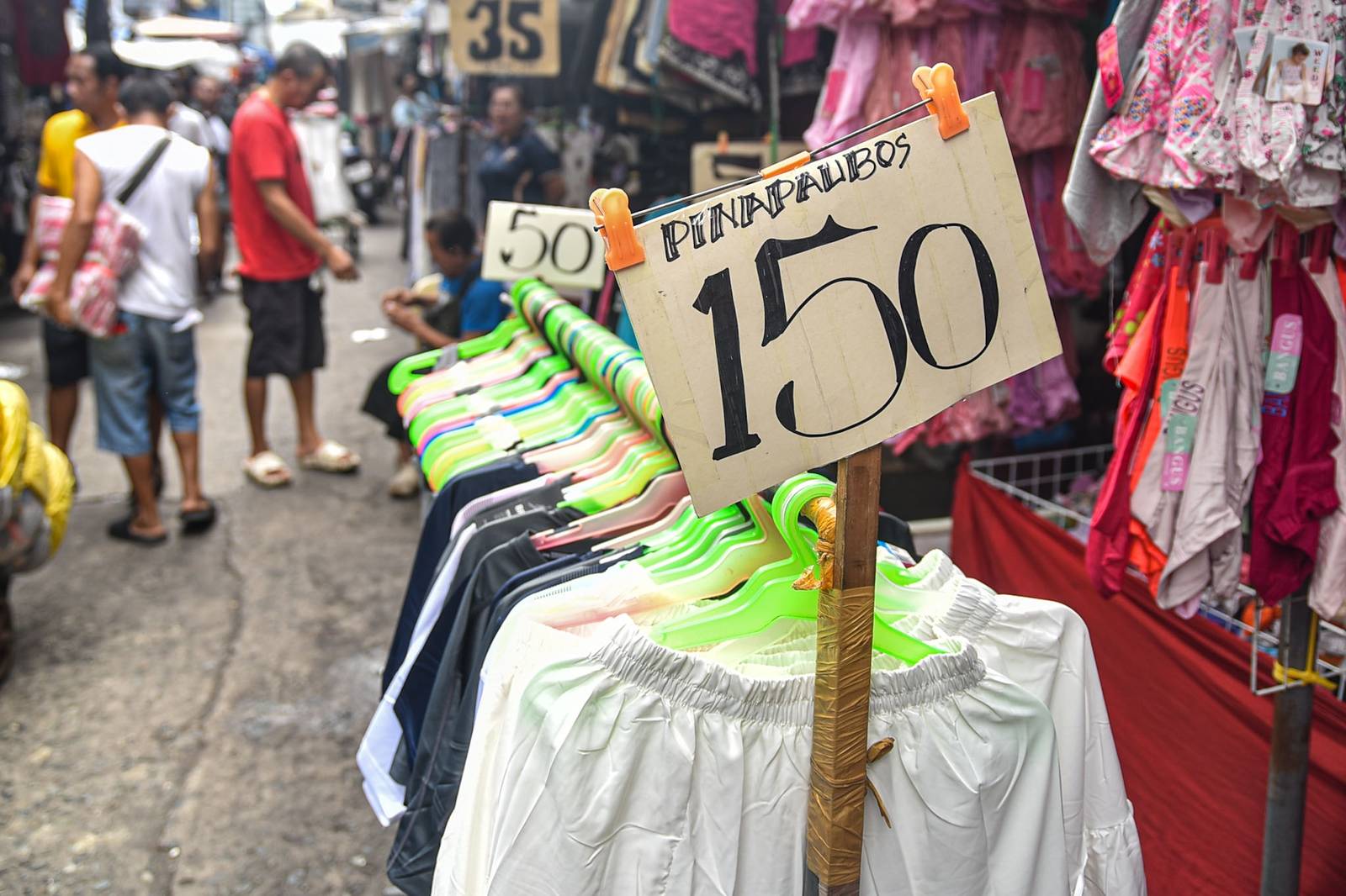 Thrifted clothes are displayed for sale along the streets of Quiapo, Manila, as vendors offer secondhand garments at affordable prices on October 10.

Filipinos turn to ukay-ukay shops and street stalls to find quality clothing at lower prices. l Zedrich Xylak Madrid