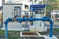 Blue water distribution pipelines and control equipment at a pumping facility.
