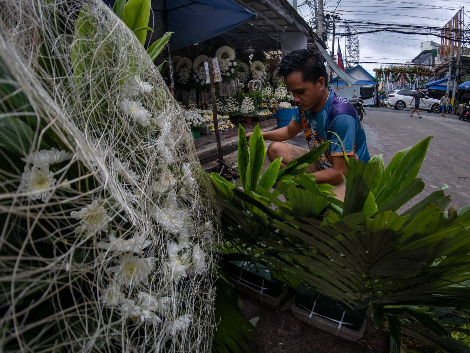 Florists arrange flowers for the dead at Dangwa Flower Market in Manila on 12 October 2026, ahead of the observance of All Saints’ Day and All Souls’ Day, collectively known as Undas. Prices of flower arrangements range from ₱100 to ₱5,000.