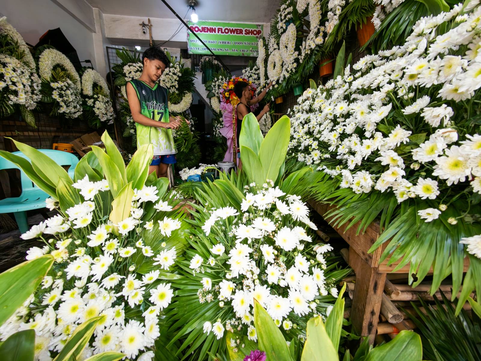 Florists arrange flowers for the dead at Dangwa Flower Market in Manila on 12 October 2026, ahead of the observance of All Saints’ Day and All Souls’ Day, collectively known as Undas. Prices of flower arrangements range from ₱100 to ₱5,000.