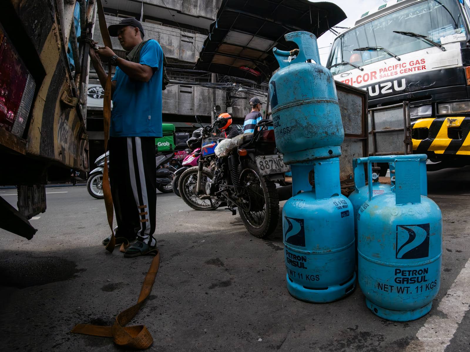 Workers unload liquefied petroleum gas (LPG) cylinders from a delivery truck in Manila on 12 October 2026. LPG prices continue to rise this month despite President Ferdinand Marcos Jr.’s temporary suspension of excise taxes, as global prices climb.