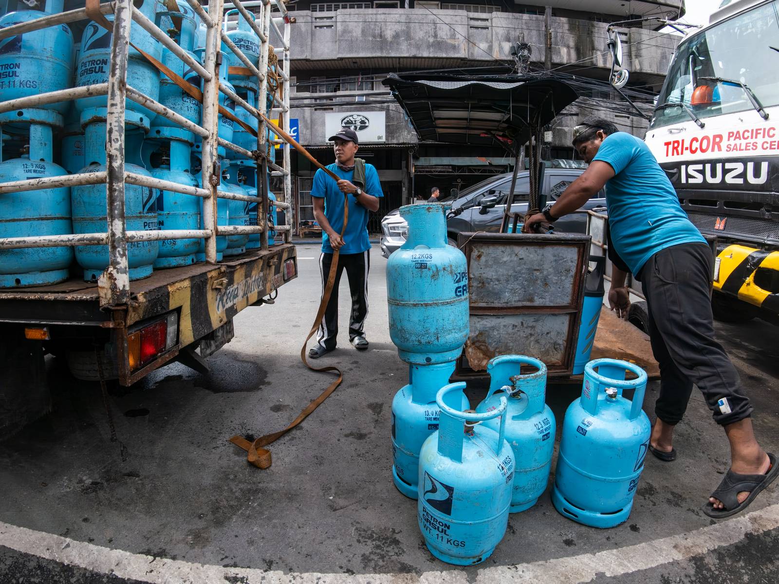 Workers unload liquefied petroleum gas (LPG) cylinders from a delivery truck in Manila on 12 October 2026. LPG prices continue to rise this month despite President Ferdinand Marcos Jr.’s temporary suspension of excise taxes, as global prices climb.