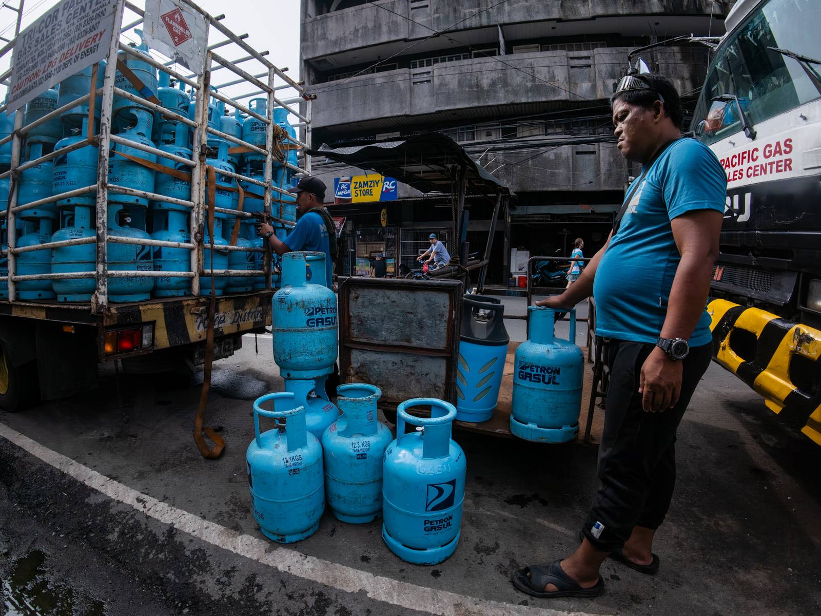 Workers unload liquefied petroleum gas (LPG) cylinders from a delivery truck in Manila on 12 October 2026. LPG prices continue to rise this month despite President Ferdinand Marcos Jr.’s temporary suspension of excise taxes, as global prices climb.