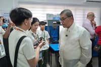 Science and Technology Secretary Renato Solidum Jr. interacts with students beside a 3D printer during the launch of the 21st Century Learning Environment Model (CLEM) Classroom at Quezon Science High School in Quezon Province.