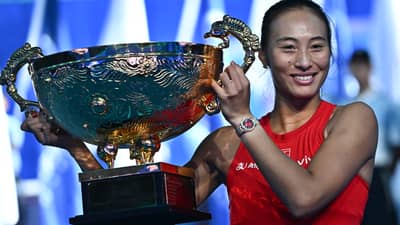 China’s Zheng Qinwen celebrates with the trophy after beating Russia’s Mirra Andreeva in the women’s singles final at the China Open tennis tournament in Beijing on October 11, 2026.