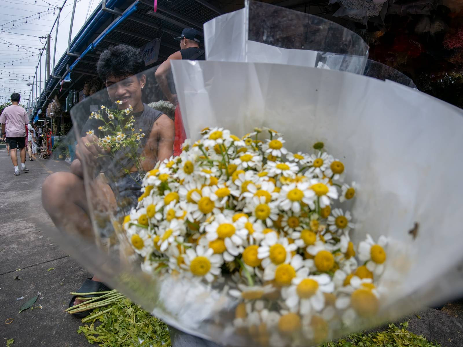 Florists arrange flowers for the dead at Dangwa Flower Market in Manila on 12 October 2026, ahead of the observance of All Saints’ Day and All Souls’ Day, collectively known as Undas. Prices of flower arrangements range from ₱100 to ₱5,000.