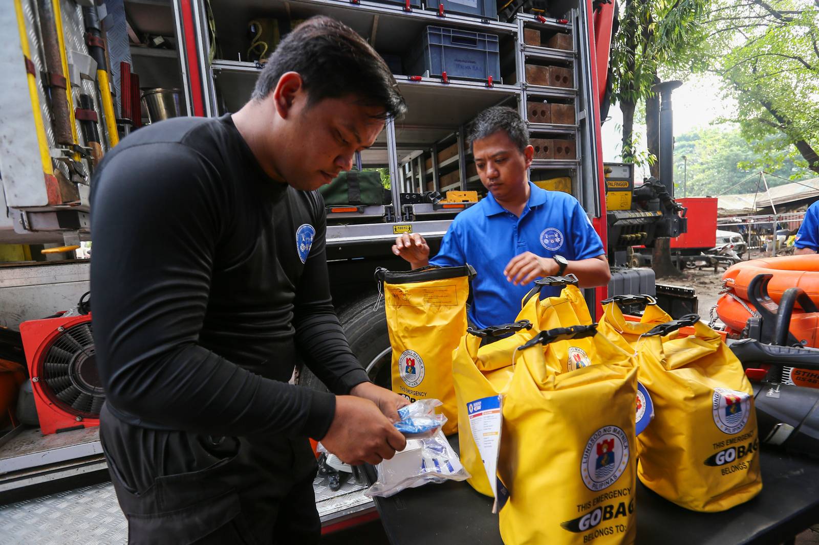 Personnel of the Manila Disaster Risk Reduction and Management Office (MDRRMO) display the contents of a go bag at their headquarters in Manila on 13 October 2026, in observance of the International Day for Disaster Risk Reduction. The annual observance highlights the importance of disaster preparedness, emphasizing that resilience starts at home through proper planning and emergency supplies.