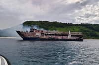 THE burned hull of the passenger vessel M/V June Aster lies grounded near the coast off Coron, Palawan, following a catastrophic fire that broke out aboard the ship.