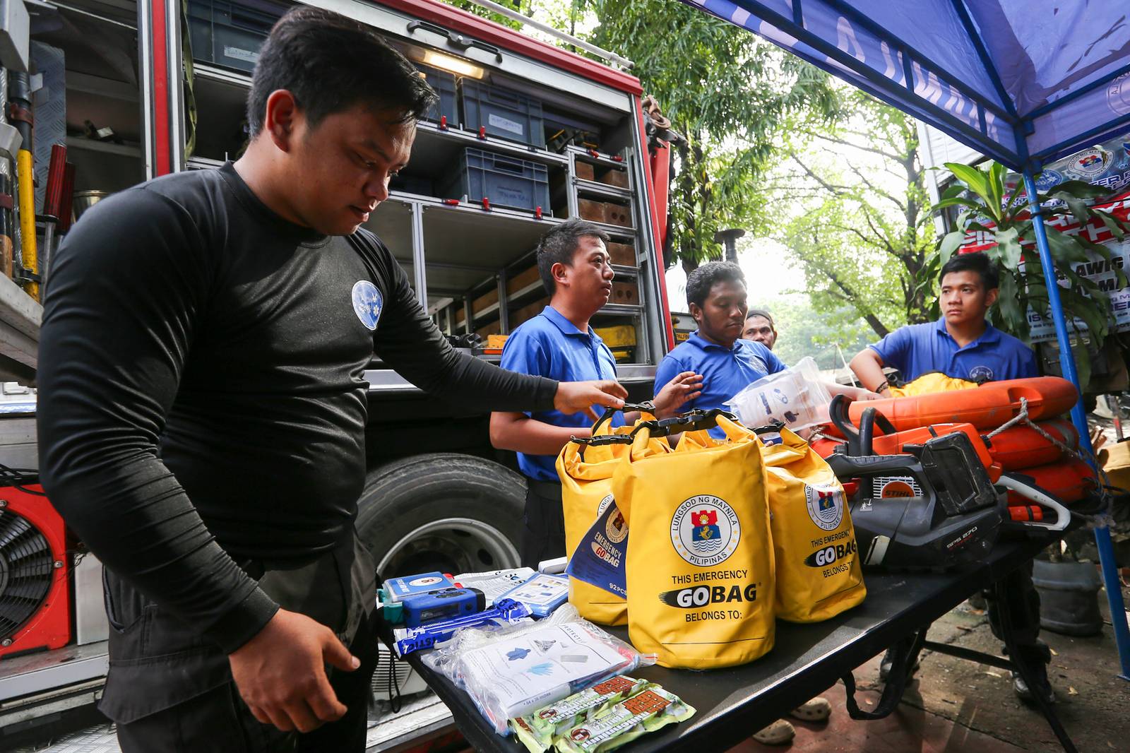 Personnel of the Manila Disaster Risk Reduction and Management Office (MDRRMO) display the contents of a go bag at their headquarters in Manila on 13 October 2026, in observance of the International Day for Disaster Risk Reduction. The annual observance highlights the importance of disaster preparedness, emphasizing that resilience starts at home through proper planning and emergency supplies.