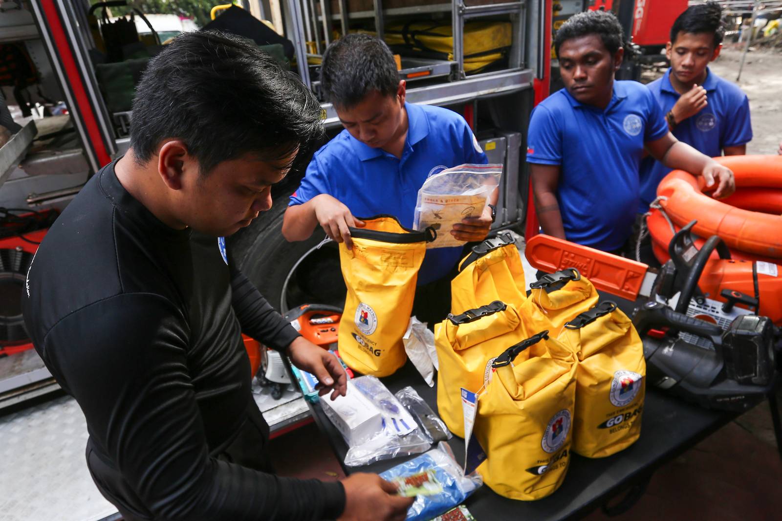 Personnel of the Manila Disaster Risk Reduction and Management Office (MDRRMO) display the contents of a go bag at their headquarters in Manila on 13 October 2026, in observance of the International Day for Disaster Risk Reduction. The annual observance highlights the importance of disaster preparedness, emphasizing that resilience starts at home through proper planning and emergency supplies.