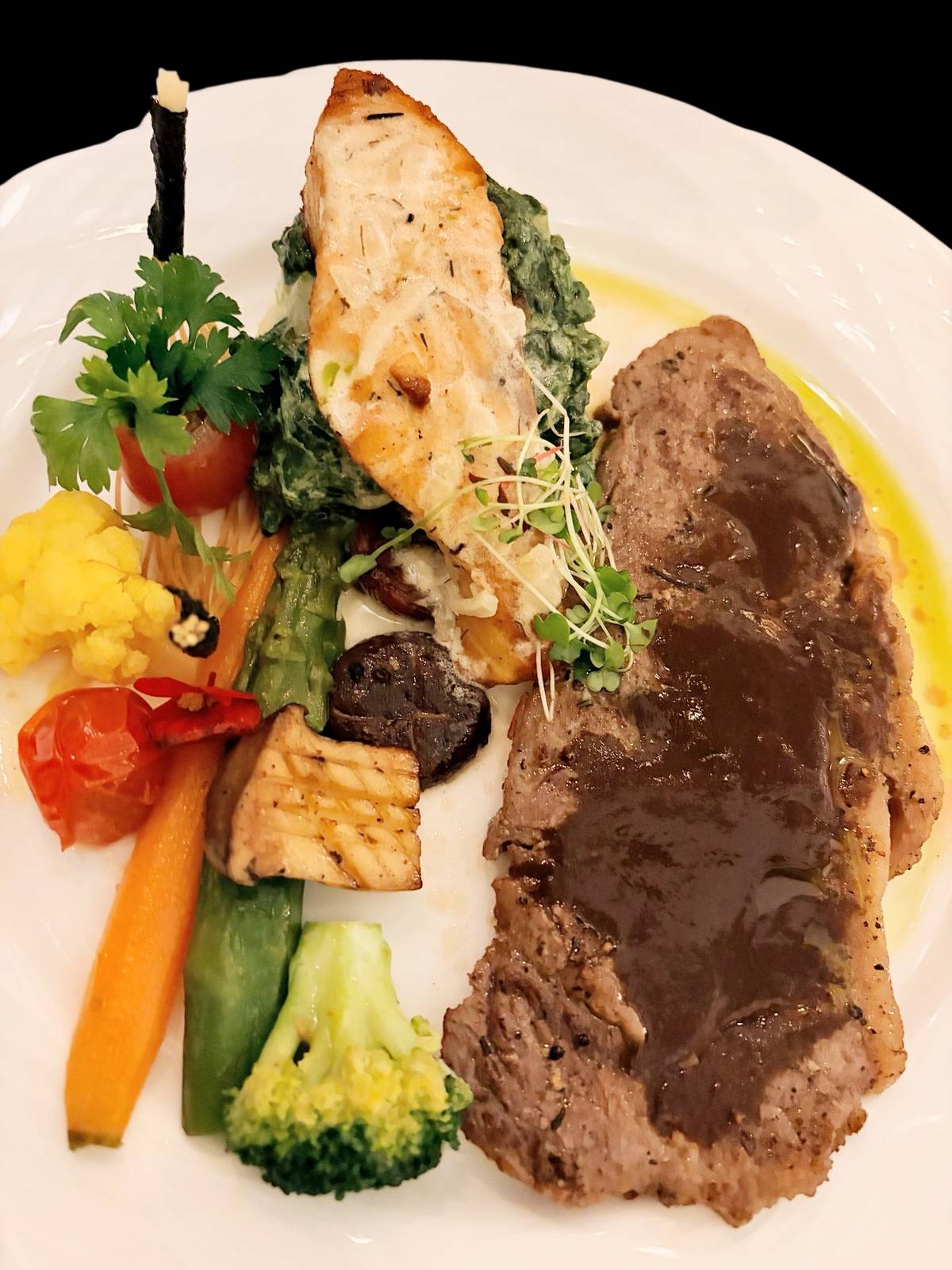 CHAMPAGNE Room’s own rendition of Surf and Turf pairs the best of land and sea on a plate.