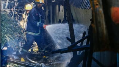 Firefighters continue to put out a 2nd alarm fire at a business establishment along Kirishima Street in BF International, Las Piñas City, on 15 October 2026. The blaze affected two schools, a warehouse, a small eatery, and two vehicles. According to the Bureau of Fire Protection (BFP), one man sustained minor injuries.