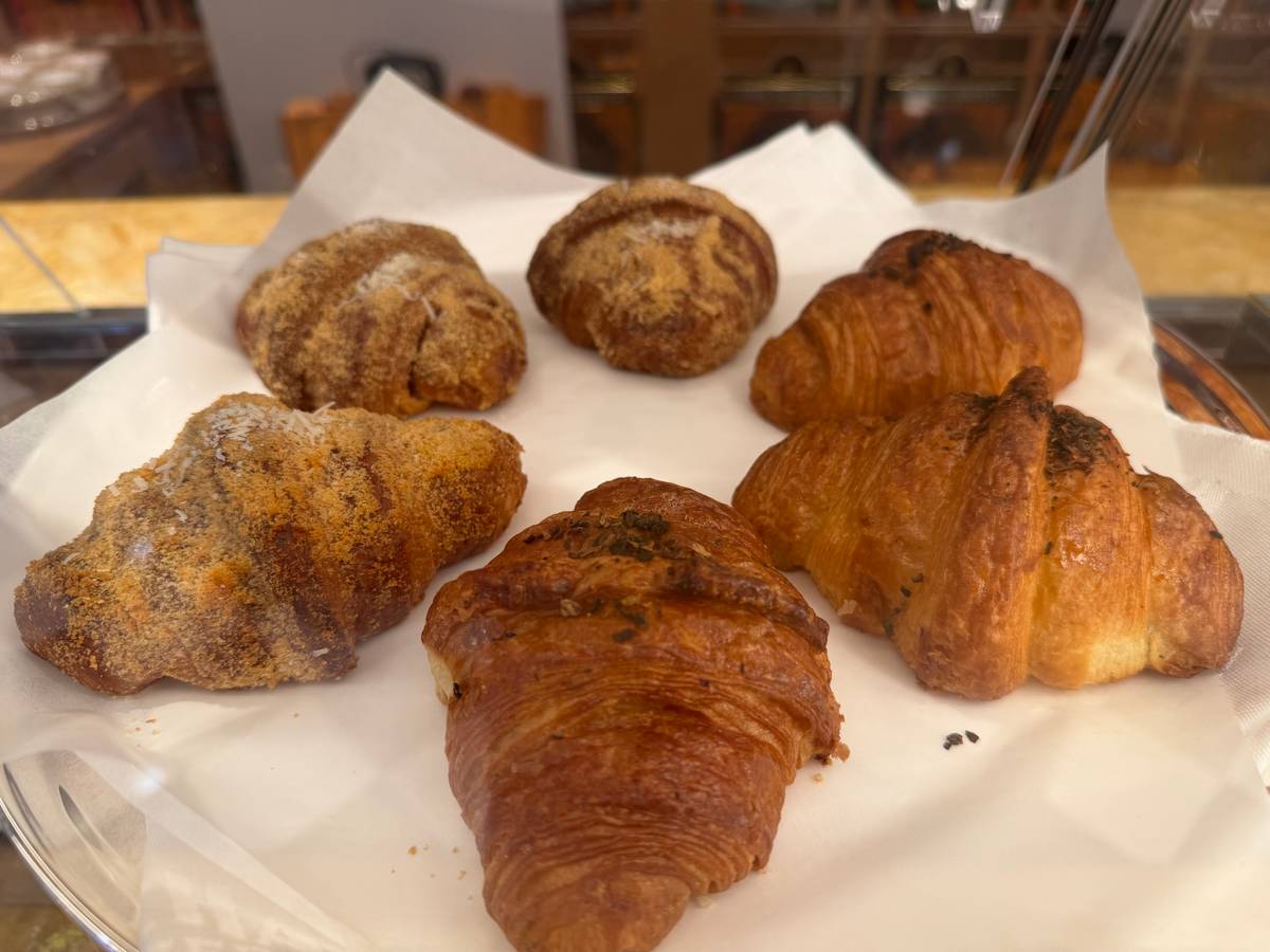 Freshly baked, golden-brown artisan croissants.