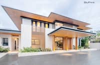 CONCRETE, glass and wood come together in a contemporary Philippine home designed around open spaces and natural light.