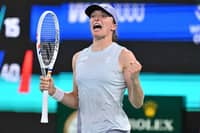 Poland's Iga Swiatek celebrates beating Switzerland's Belinda Bencic in their women’s singles match at the Wuhan Open tennis tournament in Wuhan, central China’s Hubei province on October 9, 2025.