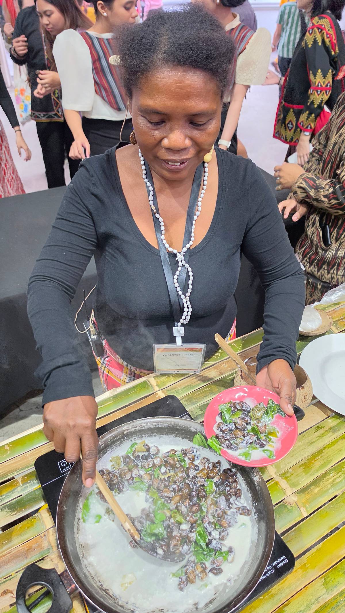 AN Ati delegate from Antique demonstrates cooking the ginataang suso (freshwater snails in coconut milk).