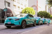 VINFAST VF 8 electric SUVs line a California street as Green SM begins its North American operations.