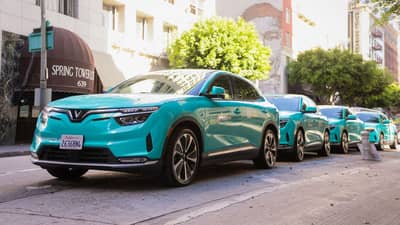 VINFAST VF 8 electric SUVs line a California street as Green SM begins its North American operations.