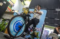 A visitor to the booth of BikedPH tries the pedal-powered blender bike platform, one of the products exhibited at the 2026 Sustainability Solutions Exchange trade fair at the Global Philippine Trade Training Center in Pasay City on 17 October 2026.