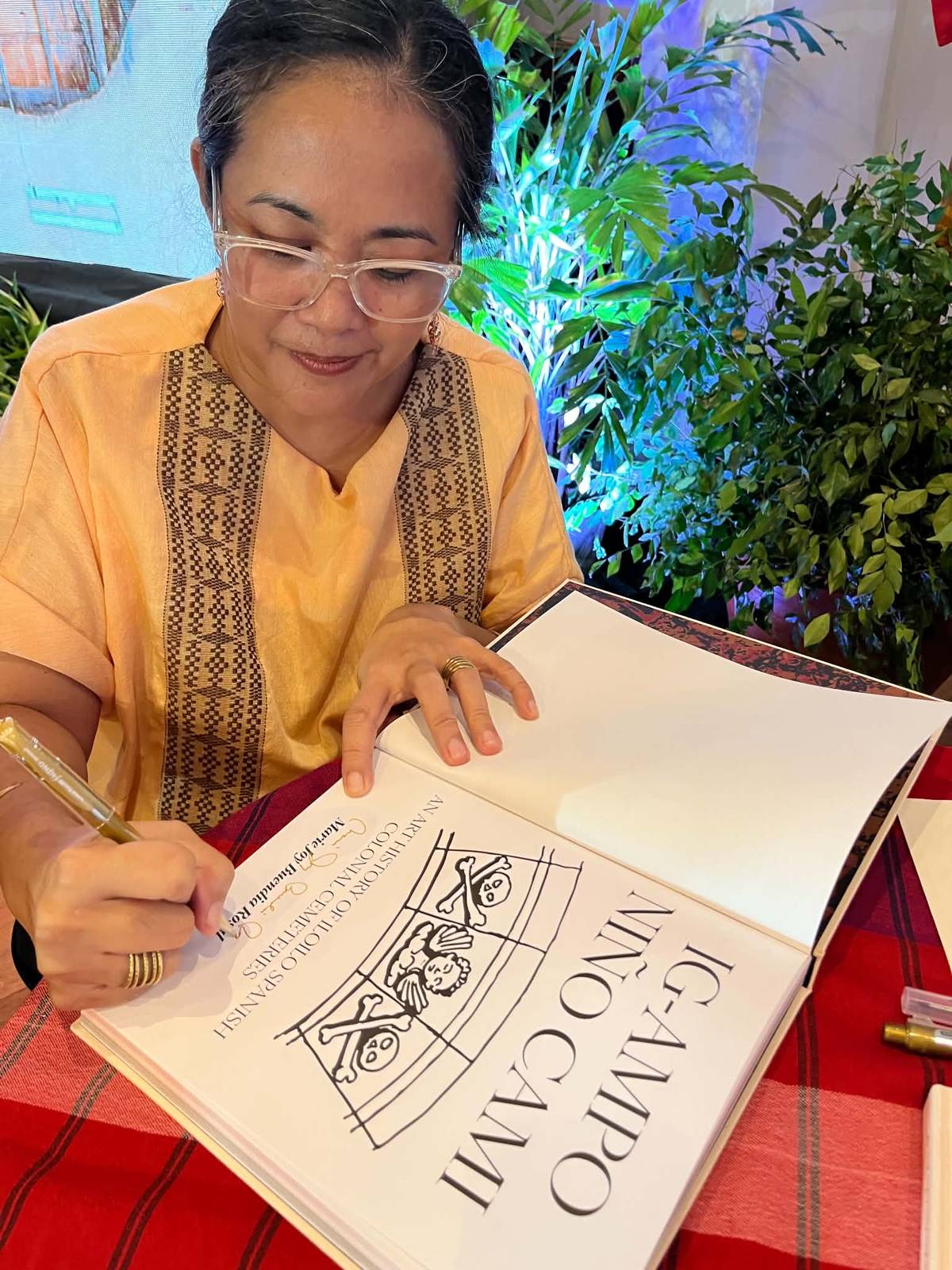 MARIE Joy Rosal signs a copy of her book, published three decades after its beginnings as a master’s thesis.
