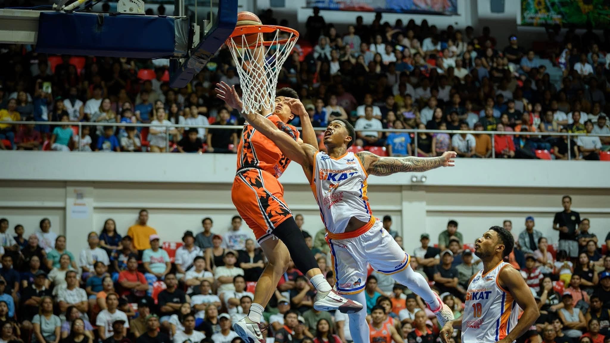 CHOLO Añonuevo dunks over Brandon Wilson during the Quezon Huskers’ 99-85 win over the Zamboanga SiKat in the South Division quarterfinals of the MPBL 2026 Season on Saturday.
