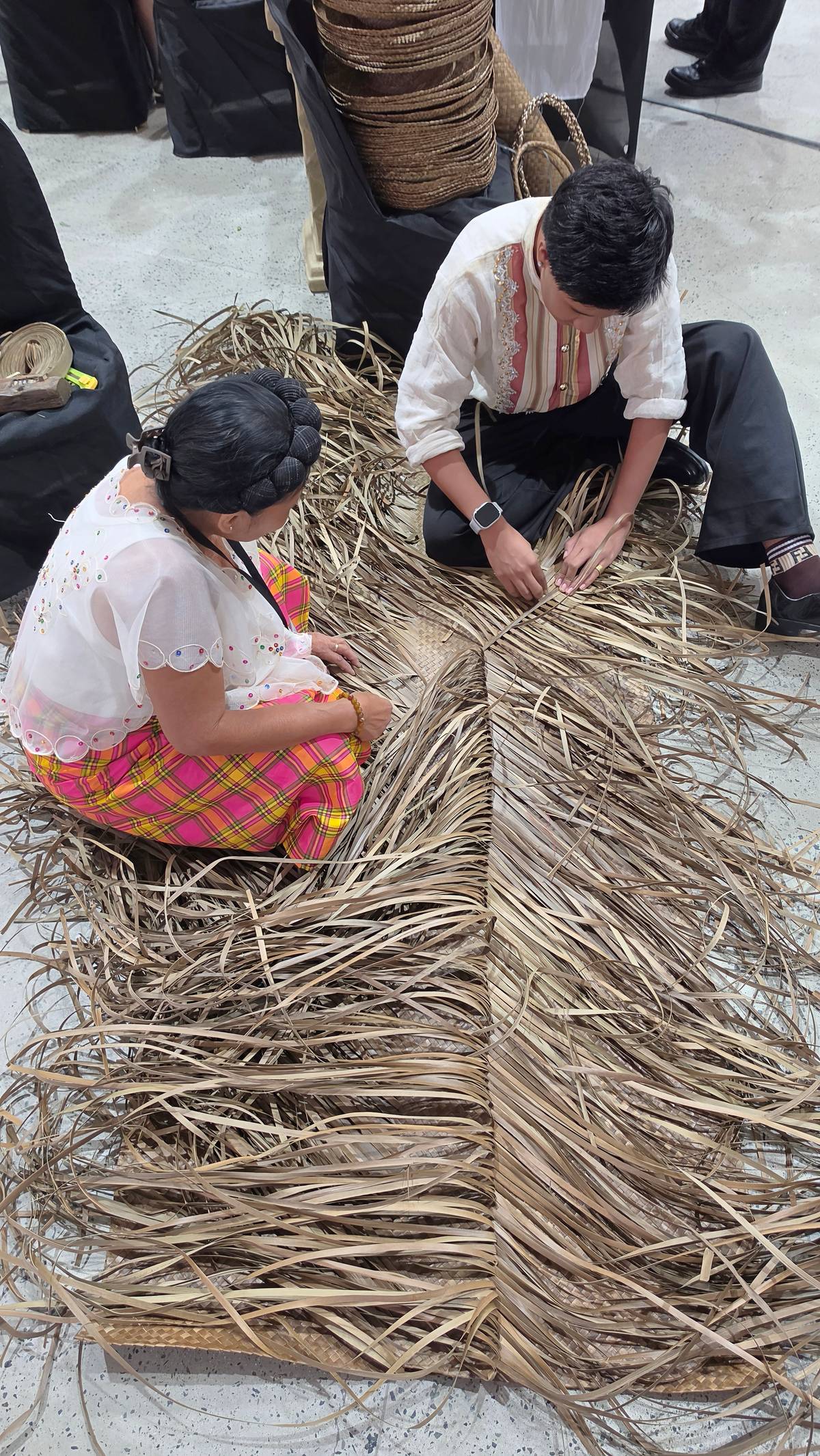AKEANON delegates from Nabas, Aklan, weaving a mat from bariw (wild pandan).