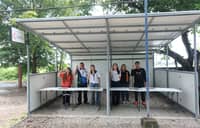 Officials from Citicore Renewables and Barangay Lumbangan pose at a facility made from upcycled solar panels in Tuy, Batangas.