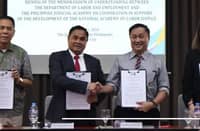 Labor Secretary Francis N. Tolentino and Philippine Judicial Academy Chancellor Justice Edgardo L. Delos Santos shake hands after signing a five-year agreement supporting the National Academy of Labor Justice in Tagaytay City on 21 October 2026. The partnership will strengthen training for officials handling labor disputes and protecting workers’ rights.