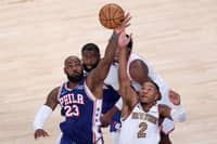 NEW YORK, NEW YORK - OCTOBER 20: LeBron James #23 of the Philadelphia 76ers and Miles McBride #2 of the New York Knicks battle for possession on a jump ball during the second quarter of the game at Madison Square Garden on October 20, 2026 in New York City.