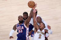 NEW YORK, NEW YORK - OCTOBER 20: LeBron James #23 of the Philadelphia 76ers and Miles McBride #2 of the New York Knicks battle for possession on a jump ball during the second quarter of the game at Madison Square Garden on October 20, 2026 in New York City.