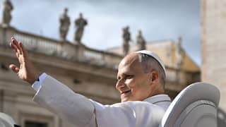 Pope Leo XIV waves to the crowd at the end of the weekly general audience at St Peter's Square in The Vatican on October 21, 2026.
Tiziana FABI / AFP