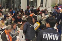 PERSONNEL from the Department of Migrant Workers and the Overseas Workers Welfare Administration assist returning overseas Filipino workers and their dependents upon their arrival at Ninoy Aquino International Airport Terminal 3 in Pasay City.