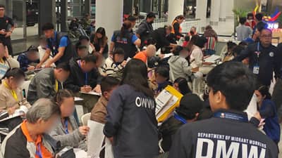 PERSONNEL from the Department of Migrant Workers and the Overseas Workers Welfare Administration assist returning overseas Filipino workers and their dependents upon their arrival at Ninoy Aquino International Airport Terminal 3 in Pasay City.