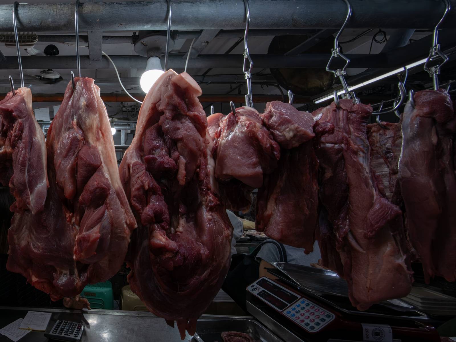Pork cuts are displayed at a meat section of a public market in Manila on 22 October 2026. Local hog raisers nationwide have launched a three-day “pork holiday” from 22 to 24 October, voluntarily suspending live hog deliveries to markets to protest mounting industry losses, rising production costs and competition from imported pork. The protest aims to urge the government to review import policies and strengthen protection for the domestic hog industry.