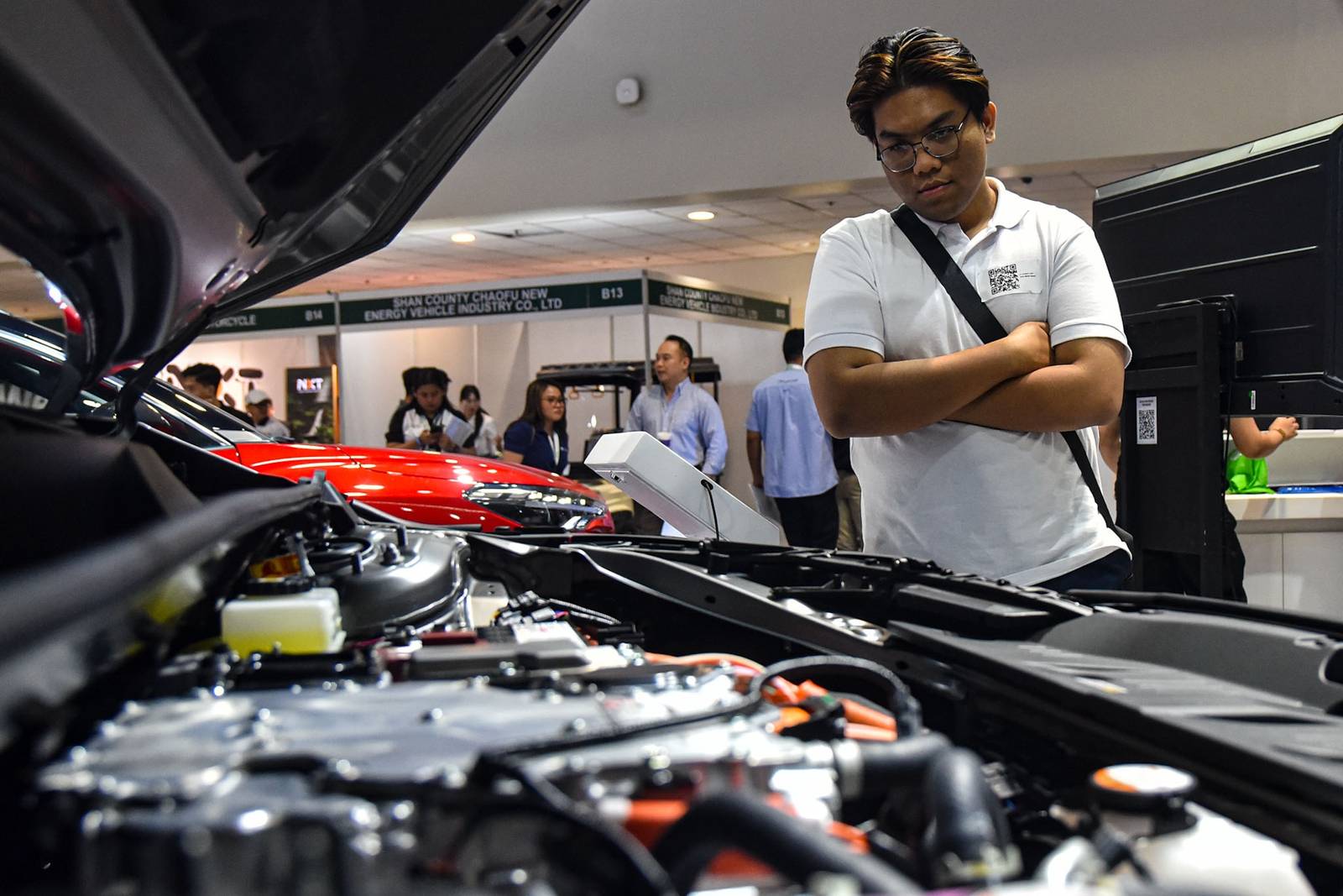 Car enthusiasts visit the 14th Philippine Electric Vehicle Summit (PEVS) 2026 to explore the latest electric vehicle models along with chargrs at the SMX Convention Center in Pasay City on October 23. 

The three-day summit runs from October 22 to 24, showcasing emerging technologies and alternatives to conventional fuel-powered vehicles. l Zedrich Xylak Madrid