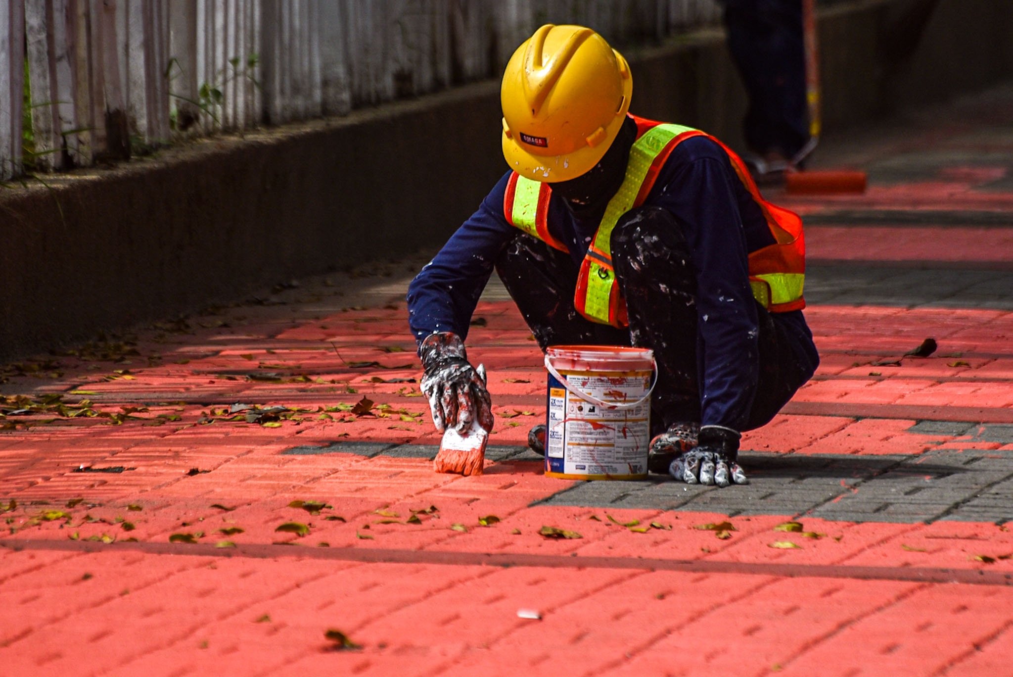 Workers repaint sidewalks along Roxas Blvd