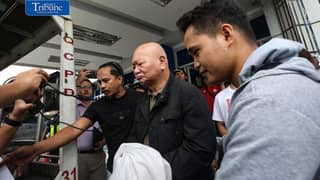 Filipino veteran journalist Philip Lustre Jr. being escorted by the Quezon City Police Station 10 for the medical examination, after he was arrested for the alleged cyberlibel complaint. Lustre was arrested after he attended the Saturday News Forum, on Saturday October 24 2026. The arrest warrant was issued by a Davao City court.