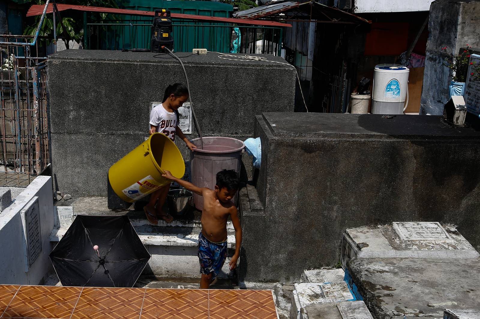 Caretakers and visitors clean and repair graves at the Pasay City Public Cemetery on 25 October 2026, ahead of the October 28 deadline for cemetery preparations for Undas.