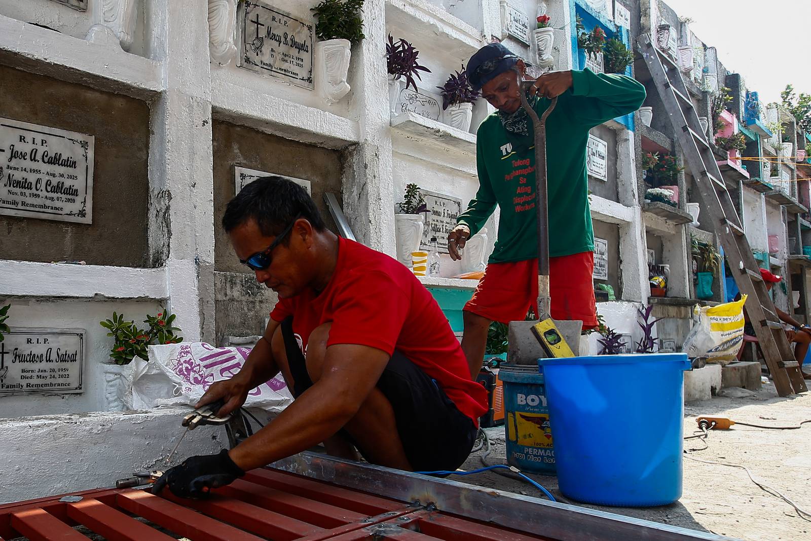 Caretakers and visitors clean and repair graves at the Pasay City Public Cemetery on 25 October 2026, ahead of the October 28 deadline for cemetery preparations for Undas.