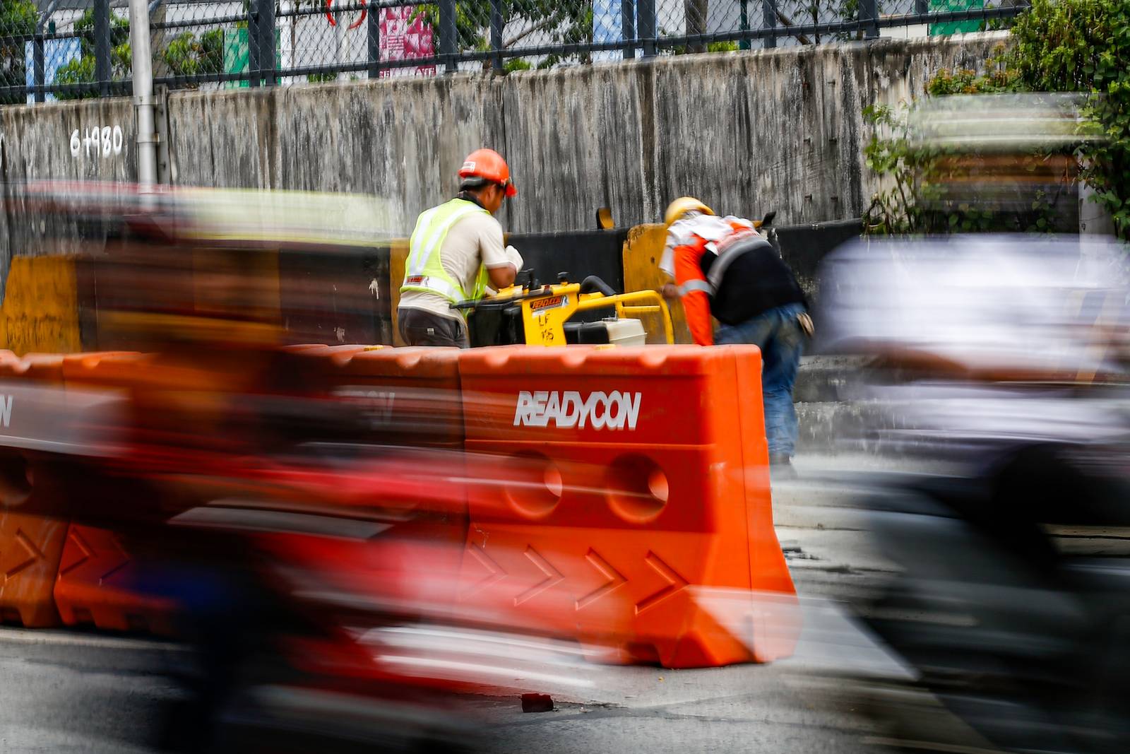 Workers rush to complete road rehabilitation along a portion of the EDSA Bus Carousel southbound lane in Quezon City on 25 October 20265, ahead of the deadline set by the Department of Public Works and Highways (DPWH) for the reopening of the affected section at 5 a.m. on 26 October 2026.