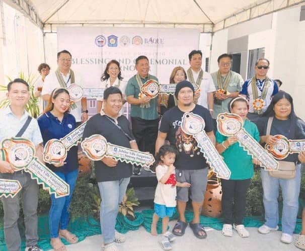 BENEFICIARIES of the Jubilee Ville Guiguinto-1 Housing Project in Bulacan receive symbolic keys to their new homes during the ceremonial awarding on October 22.