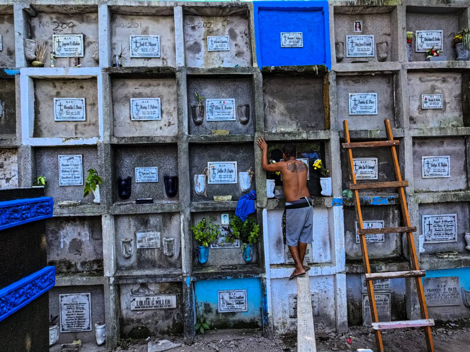 Caretakers and visitors clean and repair graves at the Pasay City Public Cemetery on 25 October 2026, ahead of the October 28 deadline for cemetery preparations for Undas.