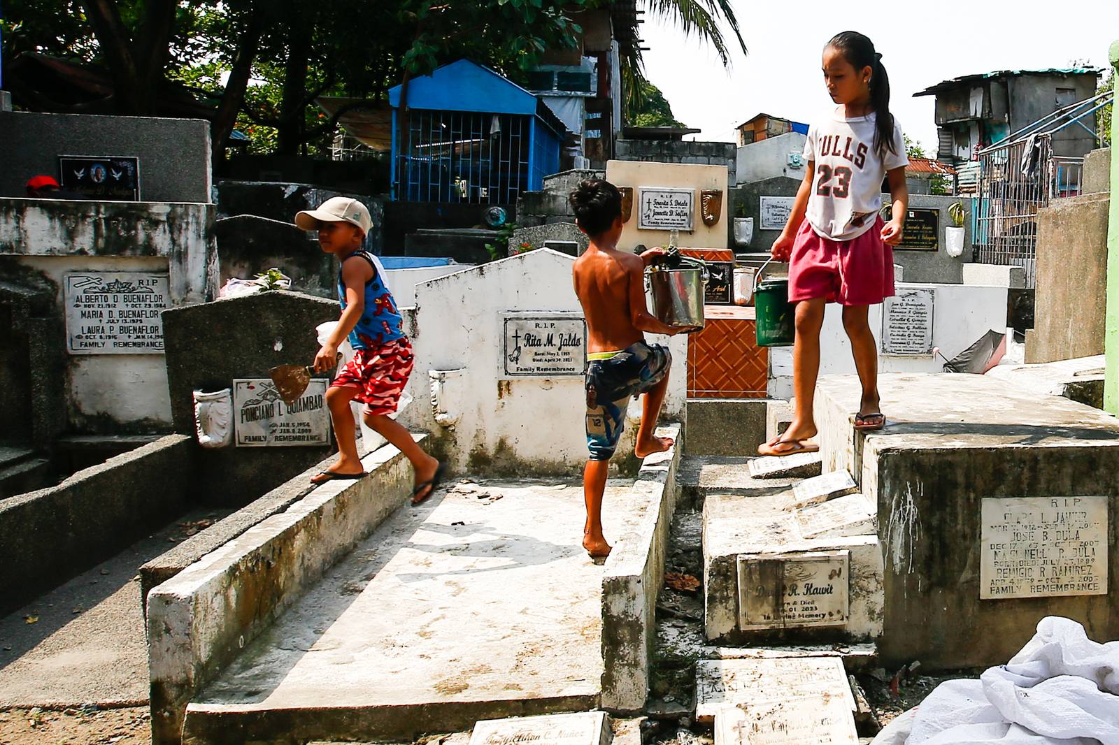 Caretakers and visitors clean and repair graves at the Pasay City Public Cemetery on 25 October 2026, ahead of the October 28 deadline for cemetery preparations for Undas.