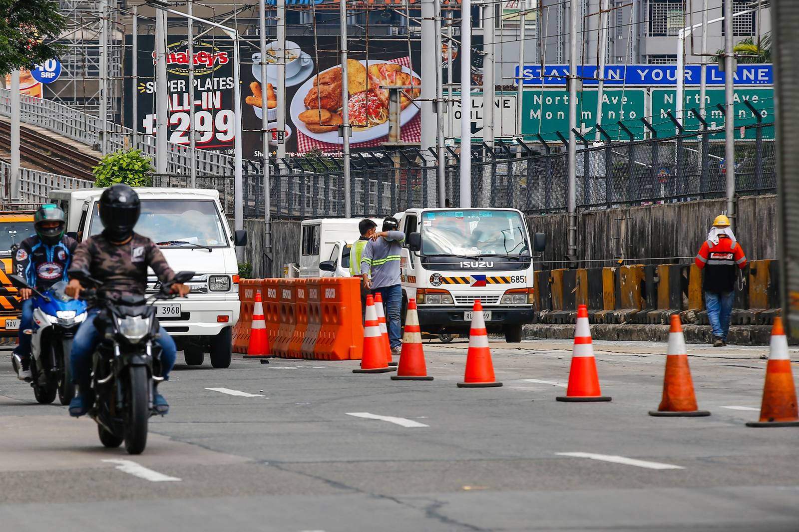 Workers rush to complete road rehabilitation along a portion of the EDSA Bus Carousel southbound lane in Quezon City on 25 October 20265, ahead of the deadline set by the Department of Public Works and Highways (DPWH) for the reopening of the affected section at 5 a.m. on 26 October 2026.