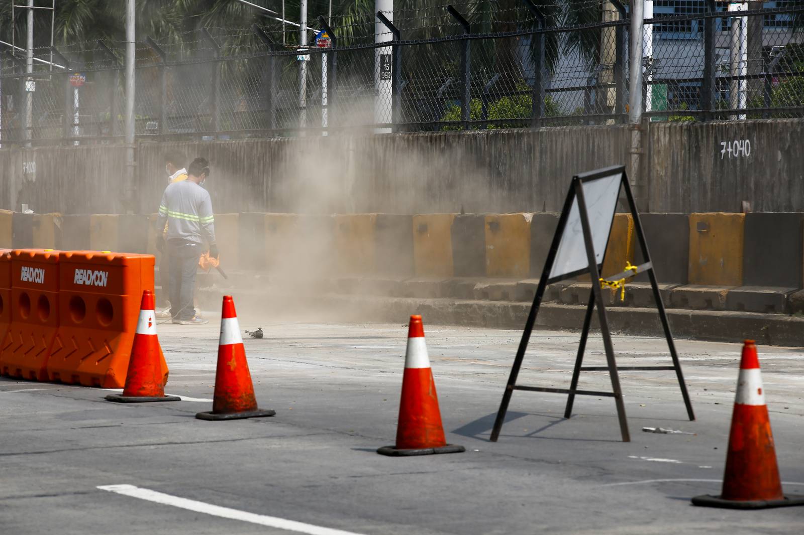 Workers rush to complete road rehabilitation along a portion of the EDSA Bus Carousel southbound lane in Quezon City on 25 October 20265, ahead of the deadline set by the Department of Public Works and Highways (DPWH) for the reopening of the affected section at 5 a.m. on 26 October 2026.