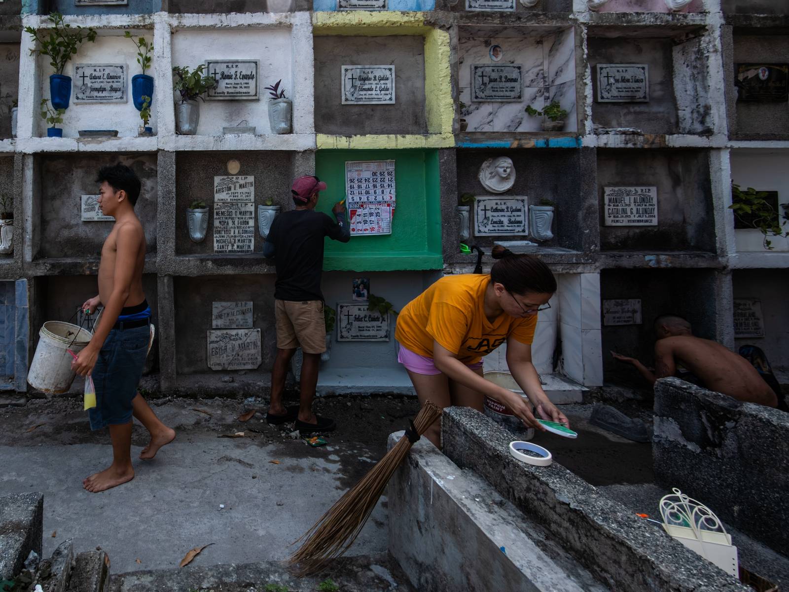 Caretakers and visitors clean and repair graves at the Pasay City Public Cemetery on 25 October 2026, ahead of the October 28 deadline for cemetery preparations for Undas.