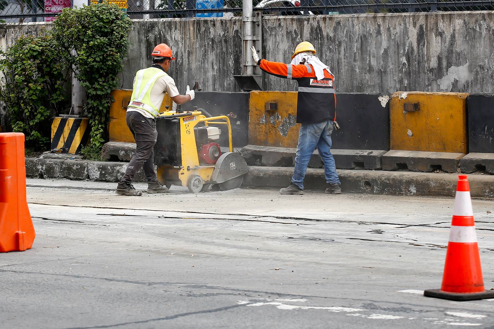Workers rush to complete road rehabilitation along a portion of the EDSA Bus Carousel southbound lane in Quezon City on 25 October 20265, ahead of the deadline set by the Department of Public Works and Highways (DPWH) for the reopening of the affected section at 5 a.m. on 26 October 2026.