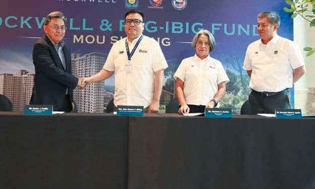 DHSUD Secretary Aliling witnesses the MOU signing between Pag-IBIG Fund CEO Acosta and Rockwell Land President Alfredo Austria aimed at widening access to homeownership opportunities.